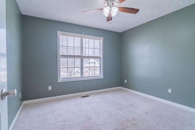 spare room with carpet flooring, a textured ceiling, and ceiling fan