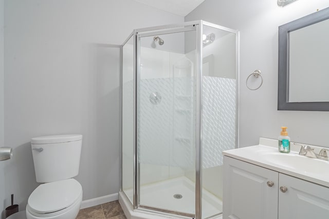 bathroom with vanity, toilet, and an enclosed shower