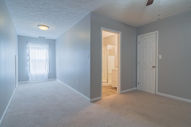 interior space with light carpet and a textured ceiling