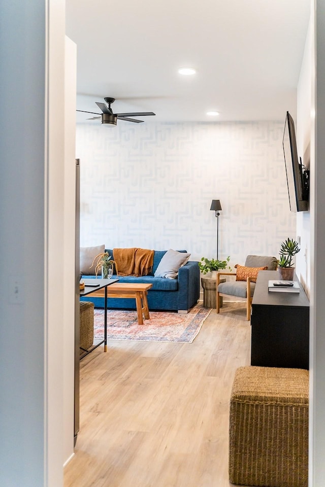 living room featuring ceiling fan and hardwood / wood-style floors