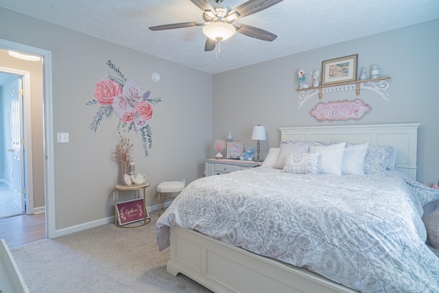 carpeted bedroom with a textured ceiling and ceiling fan