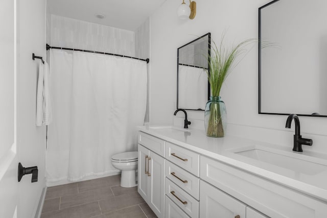 bathroom with tile patterned floors, vanity, and toilet