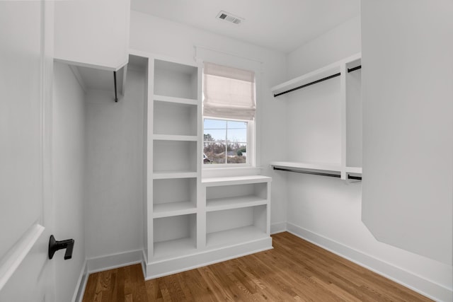 spacious closet featuring hardwood / wood-style flooring