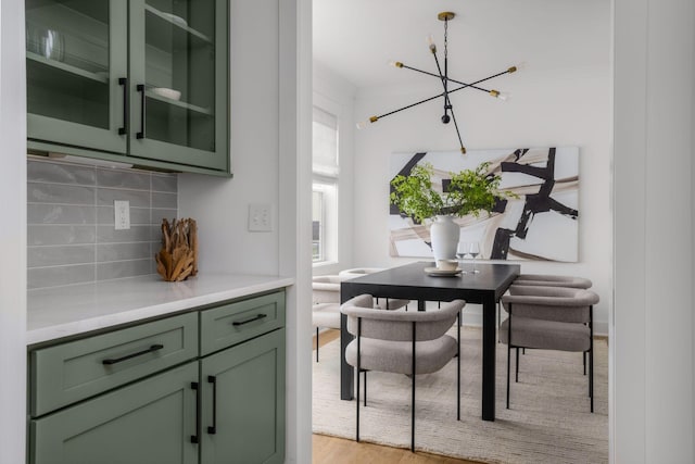 dining space featuring an inviting chandelier and light hardwood / wood-style floors