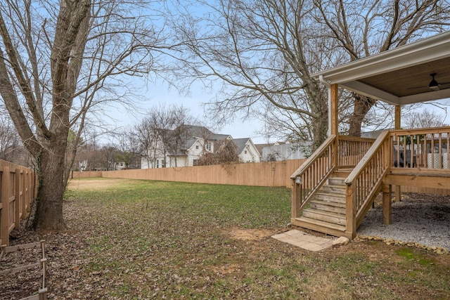 view of yard featuring ceiling fan and a deck