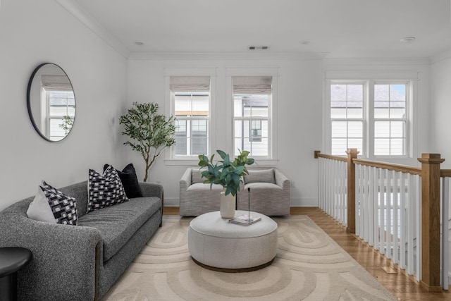 living room featuring hardwood / wood-style flooring and crown molding