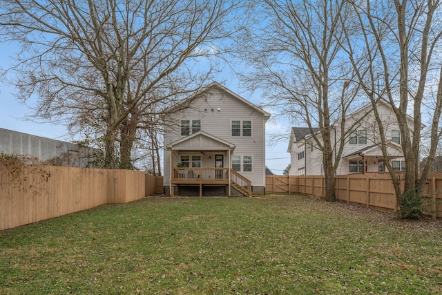 back of house with a lawn and a deck