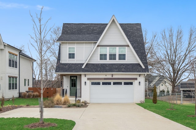 view of front of home with a front yard and a garage