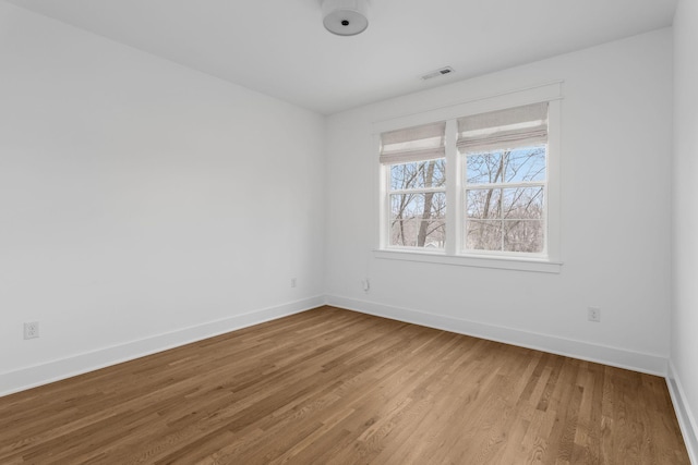 empty room with light hardwood / wood-style flooring