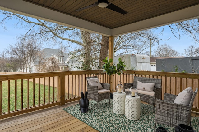 deck with a lawn, ceiling fan, and an outdoor living space