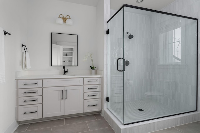 bathroom featuring vanity, an enclosed shower, and tile patterned floors