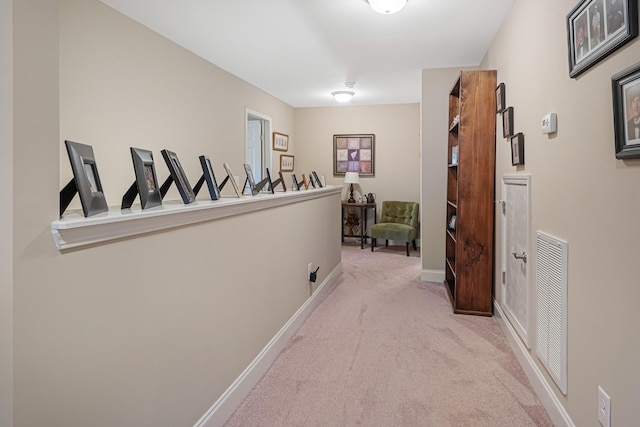 hallway featuring light colored carpet