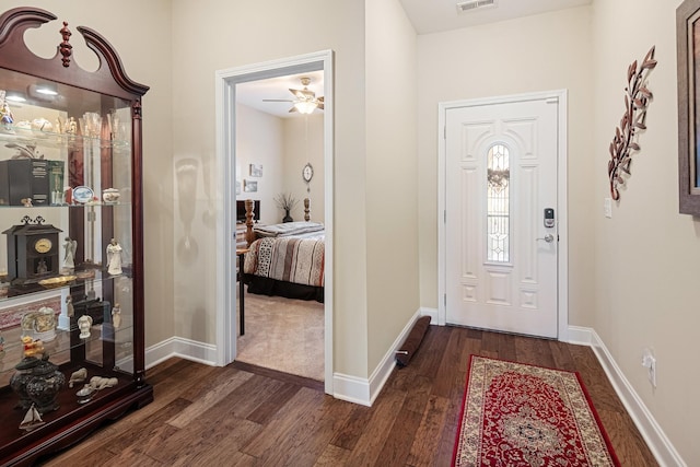 entryway with ceiling fan and dark hardwood / wood-style flooring