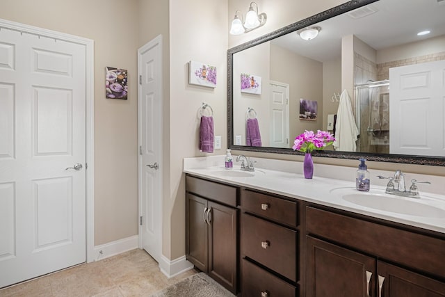 bathroom featuring tile patterned flooring, walk in shower, and vanity