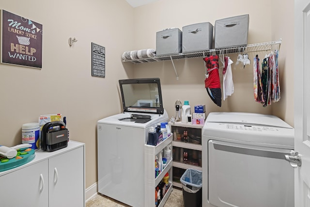 laundry area featuring cabinets and washing machine and dryer