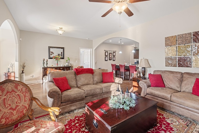 living room with ceiling fan and hardwood / wood-style flooring