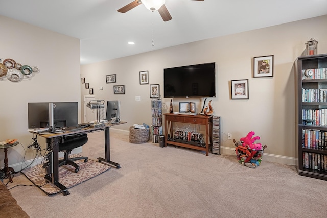 carpeted office featuring ceiling fan