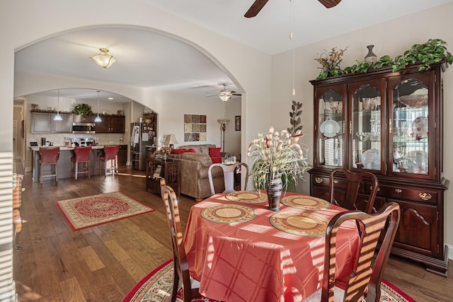 dining room with ceiling fan and dark hardwood / wood-style floors