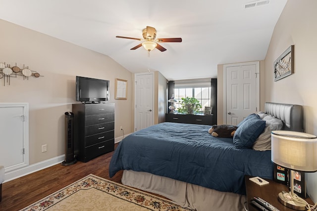 bedroom with ceiling fan, dark hardwood / wood-style flooring, and lofted ceiling