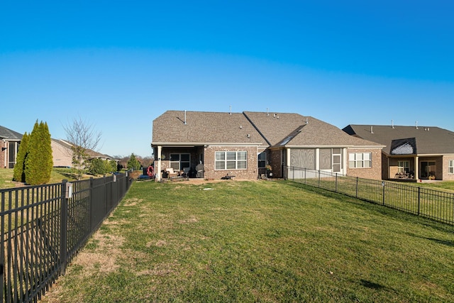 rear view of house featuring a lawn