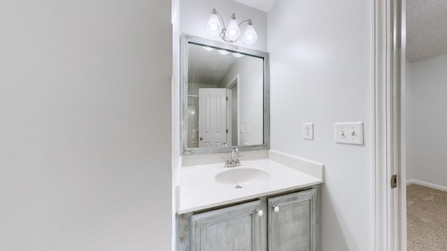 bathroom with a textured ceiling and vanity