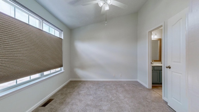 carpeted spare room with lofted ceiling, sink, and ceiling fan