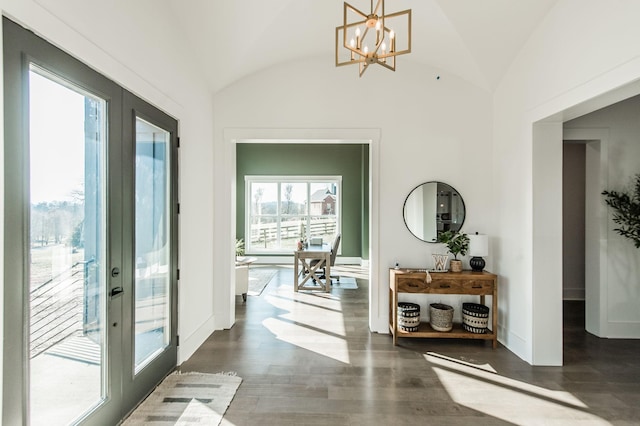 hallway featuring lofted ceiling, dark hardwood / wood-style floors, a notable chandelier, and french doors