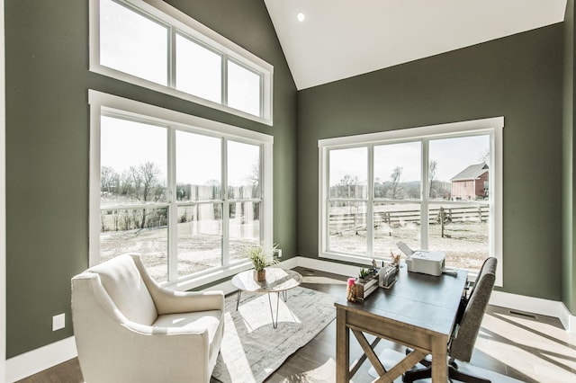 sunroom with lofted ceiling and a healthy amount of sunlight