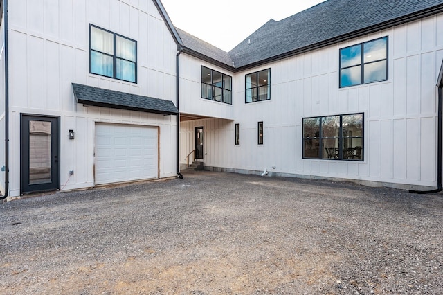 rear view of house featuring a garage