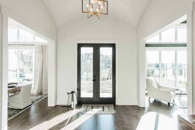 doorway to outside featuring vaulted ceiling, dark wood-type flooring, and french doors