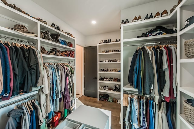 walk in closet with hardwood / wood-style floors