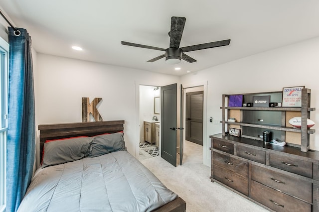 carpeted bedroom featuring connected bathroom and ceiling fan