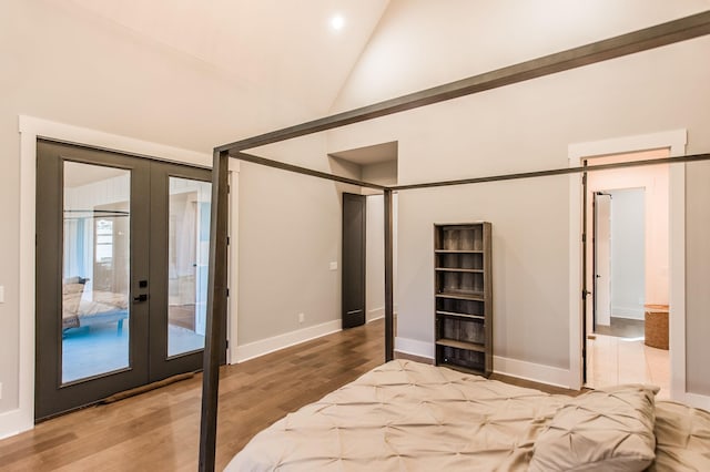 bedroom with french doors, high vaulted ceiling, light hardwood / wood-style flooring, and access to outside