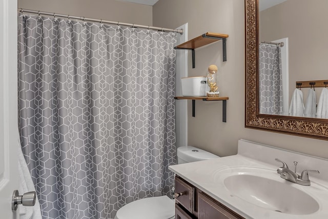 bathroom with toilet, vanity, and a shower with curtain