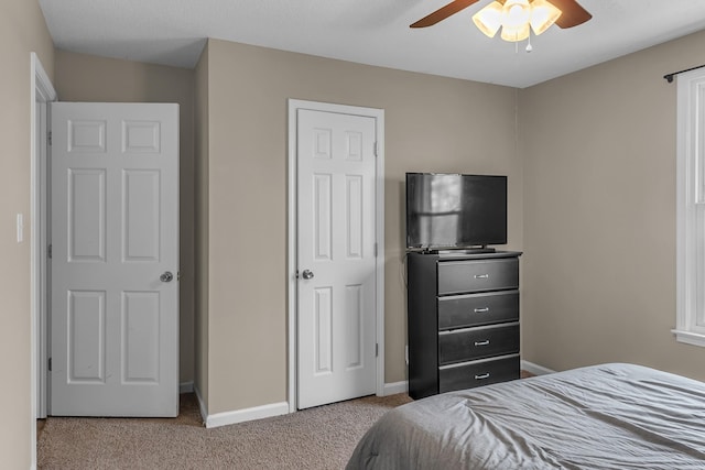 bedroom with ceiling fan and light carpet