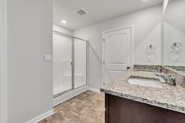 bathroom featuring an enclosed shower and vanity