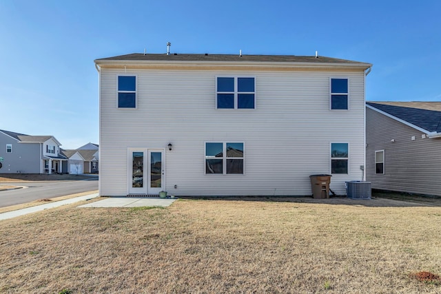 rear view of property with central AC, a yard, and a patio