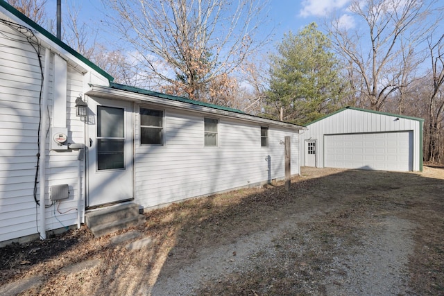 view of side of property featuring a garage and an outdoor structure