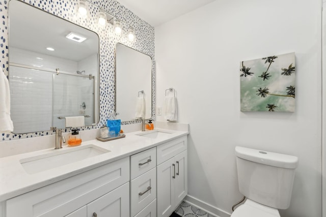 bathroom with toilet, a shower with shower door, and vanity