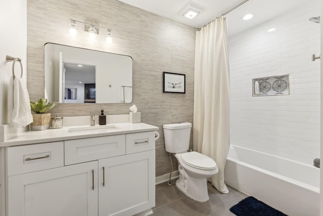 full bathroom with toilet, shower / bath combo with shower curtain, tile walls, tile patterned floors, and vanity