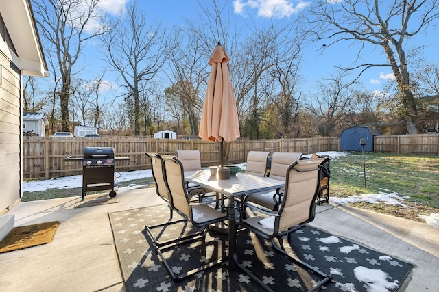 view of patio / terrace featuring a storage unit and a grill