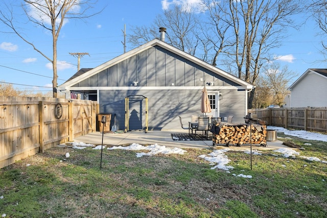 rear view of property with a lawn and a patio area