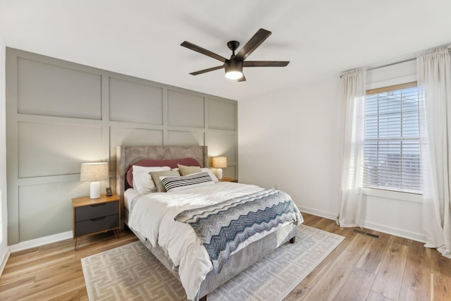 bedroom with ceiling fan and light hardwood / wood-style floors