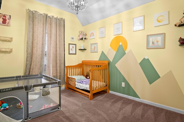 bedroom featuring vaulted ceiling, a nursery area, and carpet