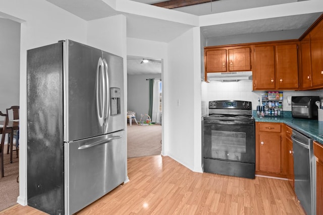 kitchen featuring beamed ceiling, decorative backsplash, light hardwood / wood-style flooring, and appliances with stainless steel finishes