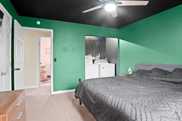 carpeted bedroom featuring ceiling fan and washer and dryer