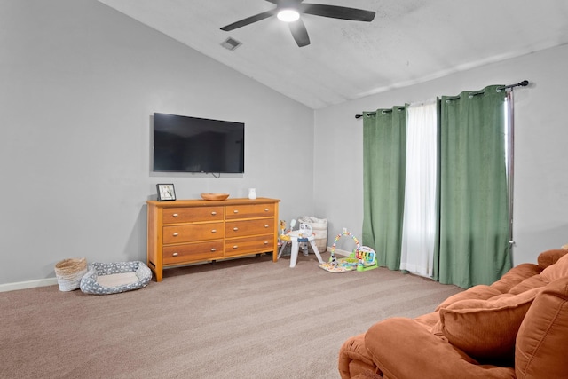 game room with ceiling fan, light colored carpet, and vaulted ceiling