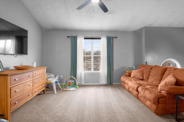 carpeted living room with a textured ceiling and ceiling fan