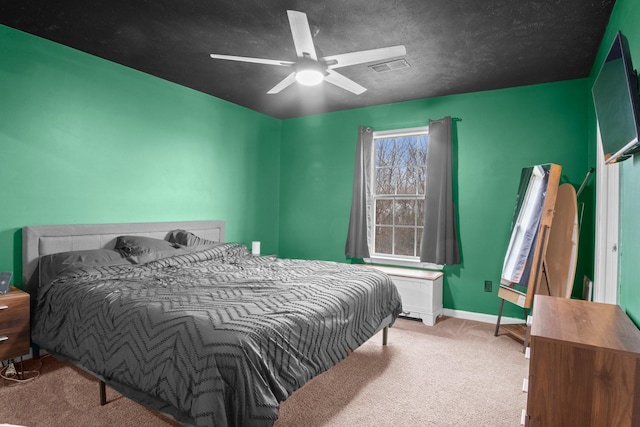 carpeted bedroom featuring a textured ceiling and ceiling fan