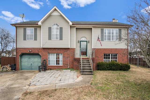 bi-level home featuring a front yard and a garage